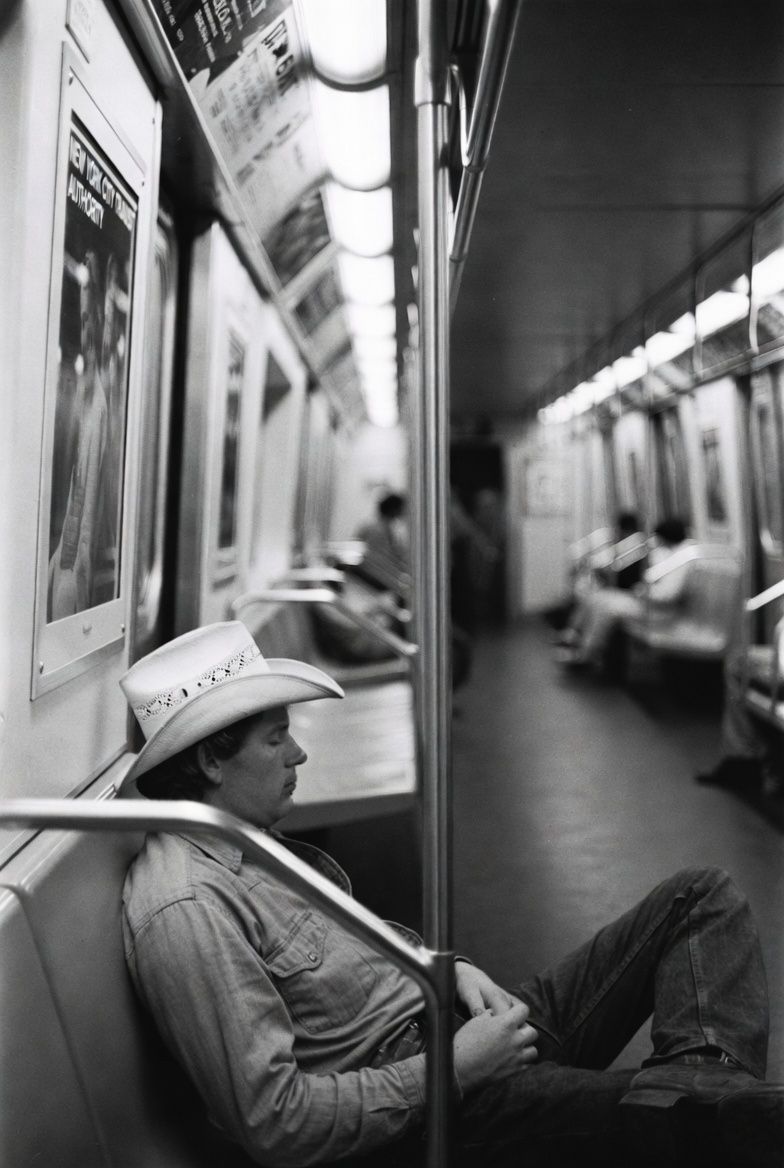 vintage black and white photo of a relaxed cowboy casually sleeping on the NYC s