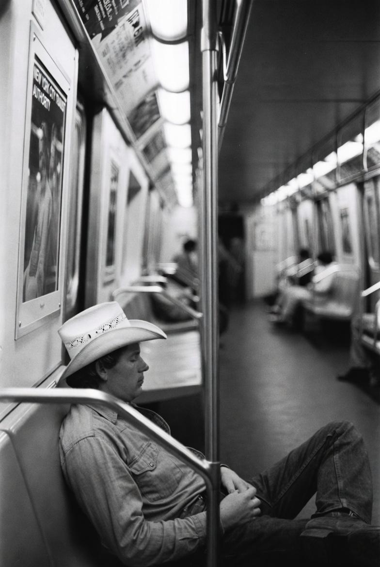 vintage black and white photo of a relaxed cowboy casually sleeping on the NYC s