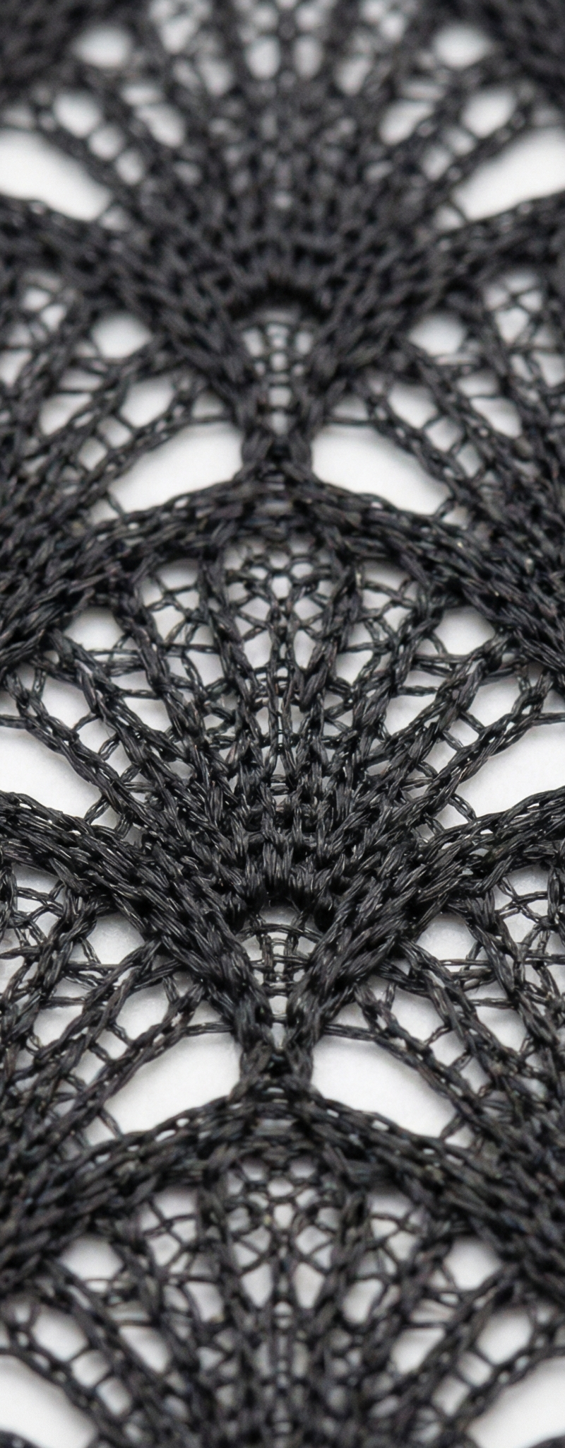 Extreme close-up macro photography of a double-layer black mesh fabric with a fa