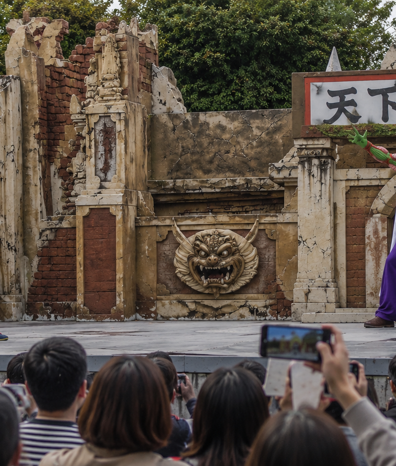 A wide-angle documentary photo of an outdoor live stage performance, two Dragon 