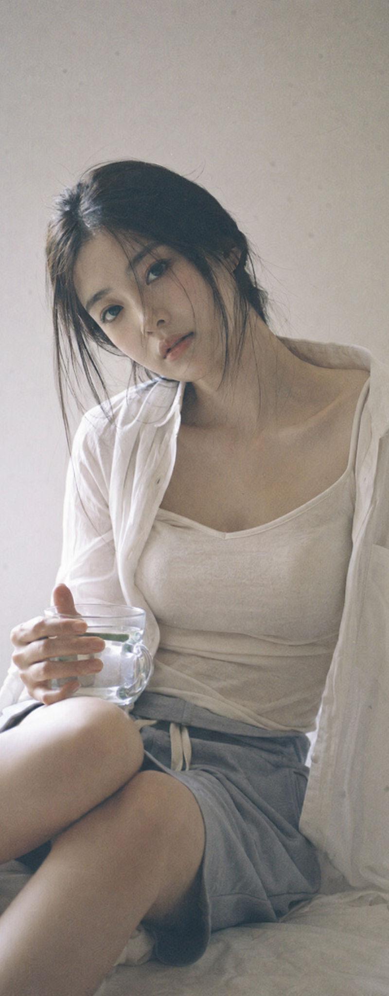 Japanese negative film aesthetic, quiet indoor corner, soft natural light, sligh