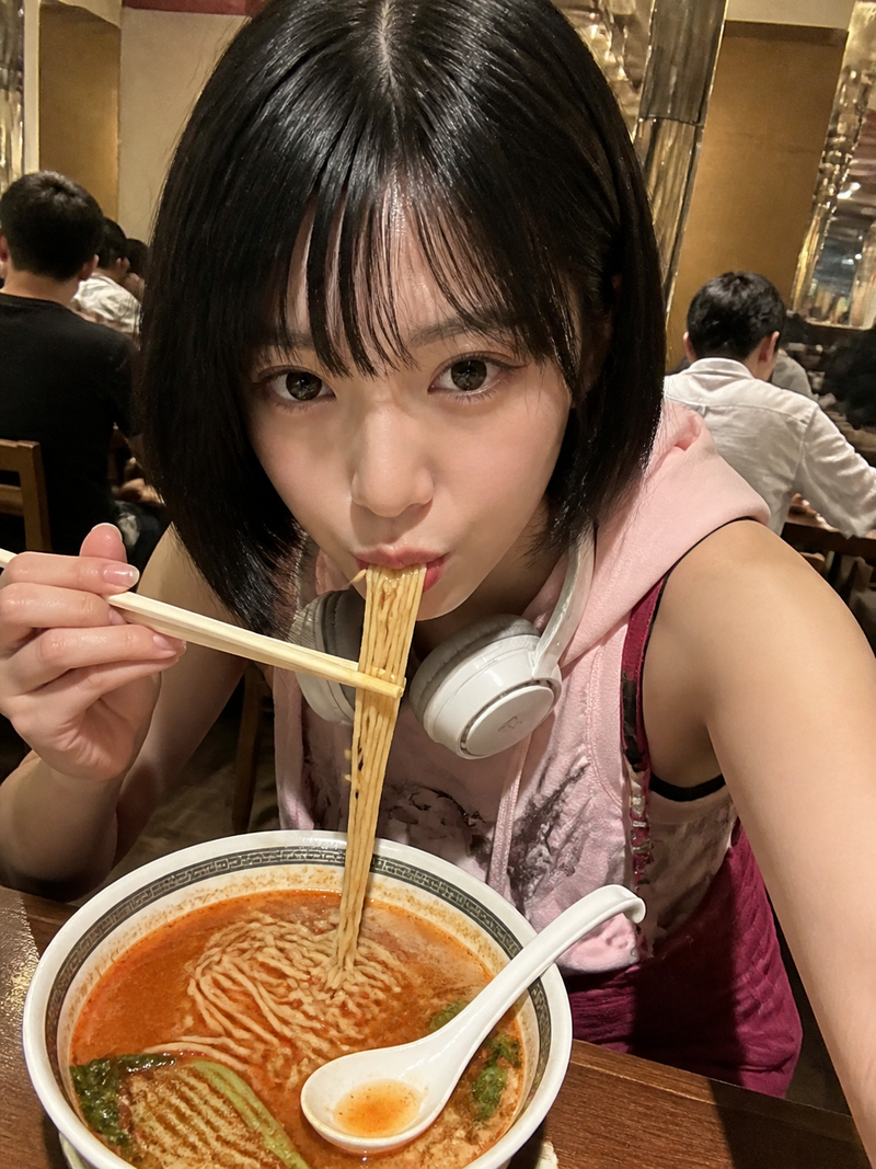 { "subject": { "description": "A young adult woman in a candid ramen-eating self