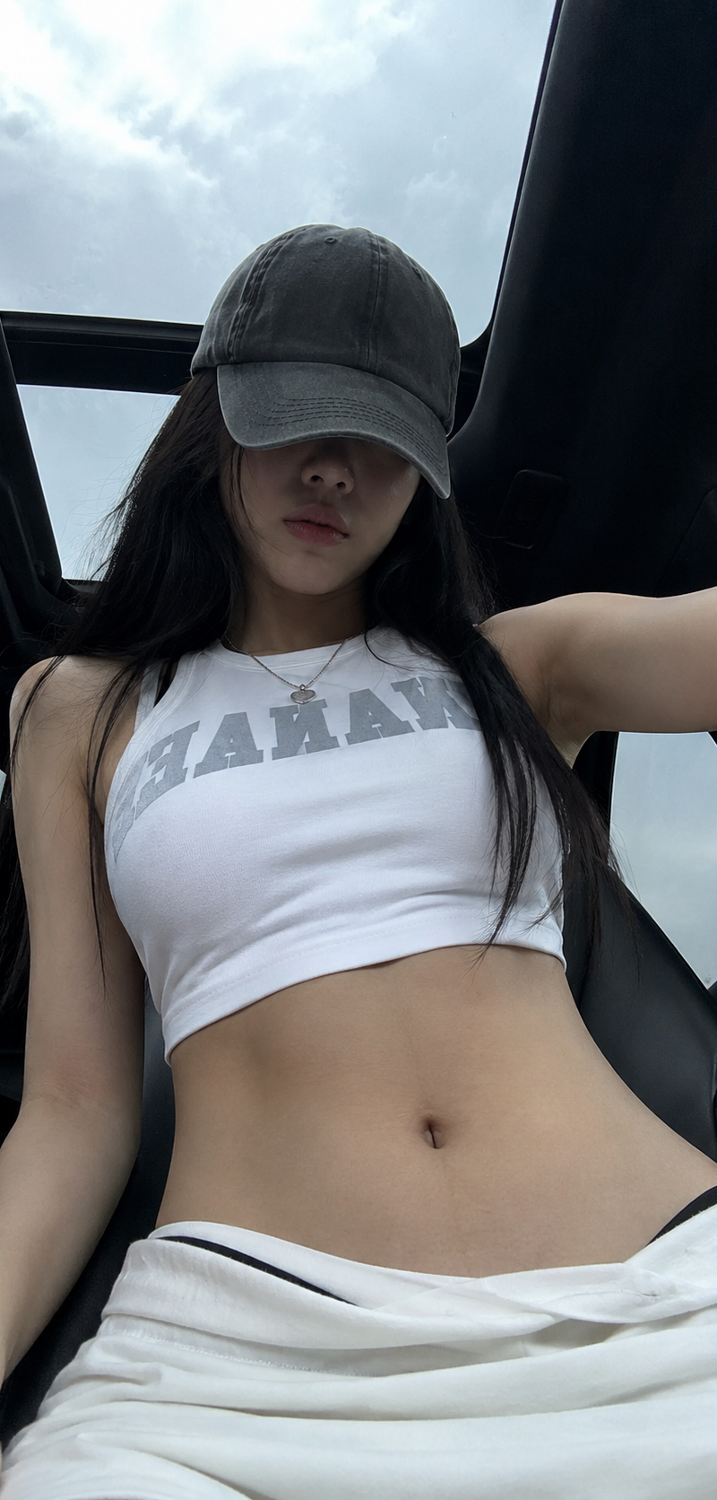 { "subject": { "description": "A young adult woman inside a car, captured in a c