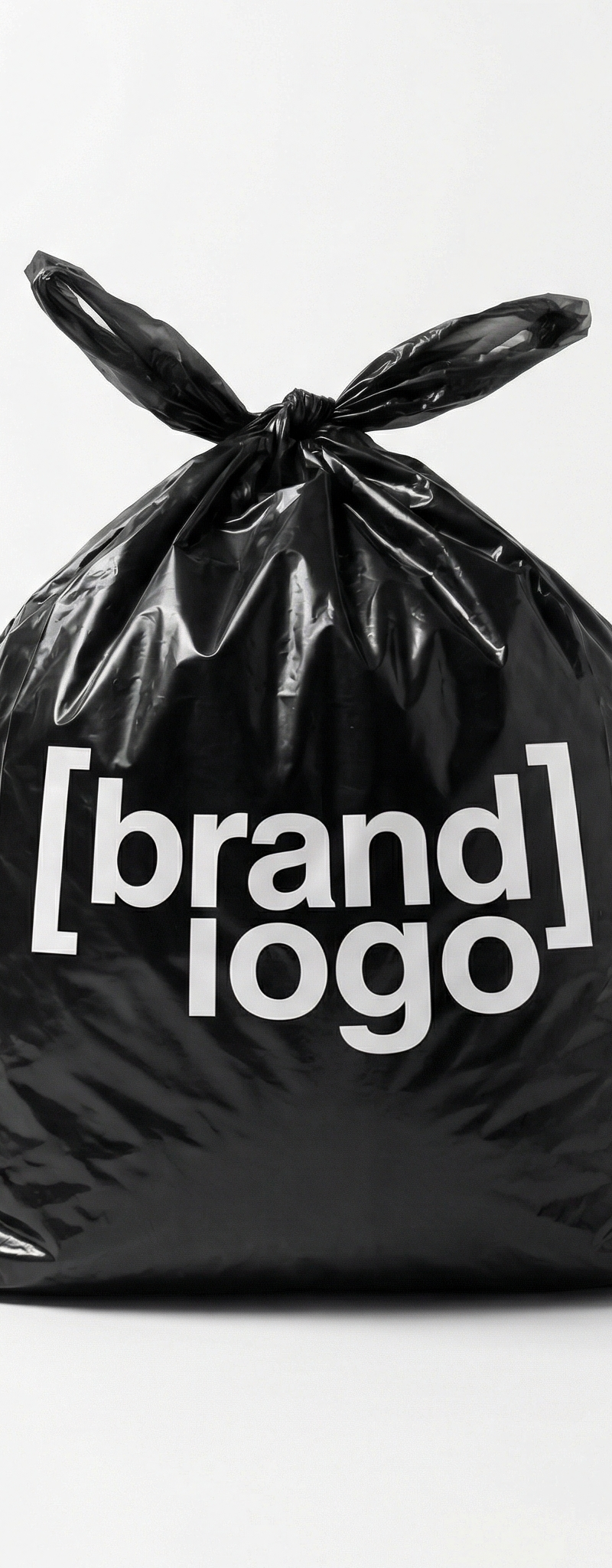 [brand name], minimalist studio product photo, single black plastic bag tied at 