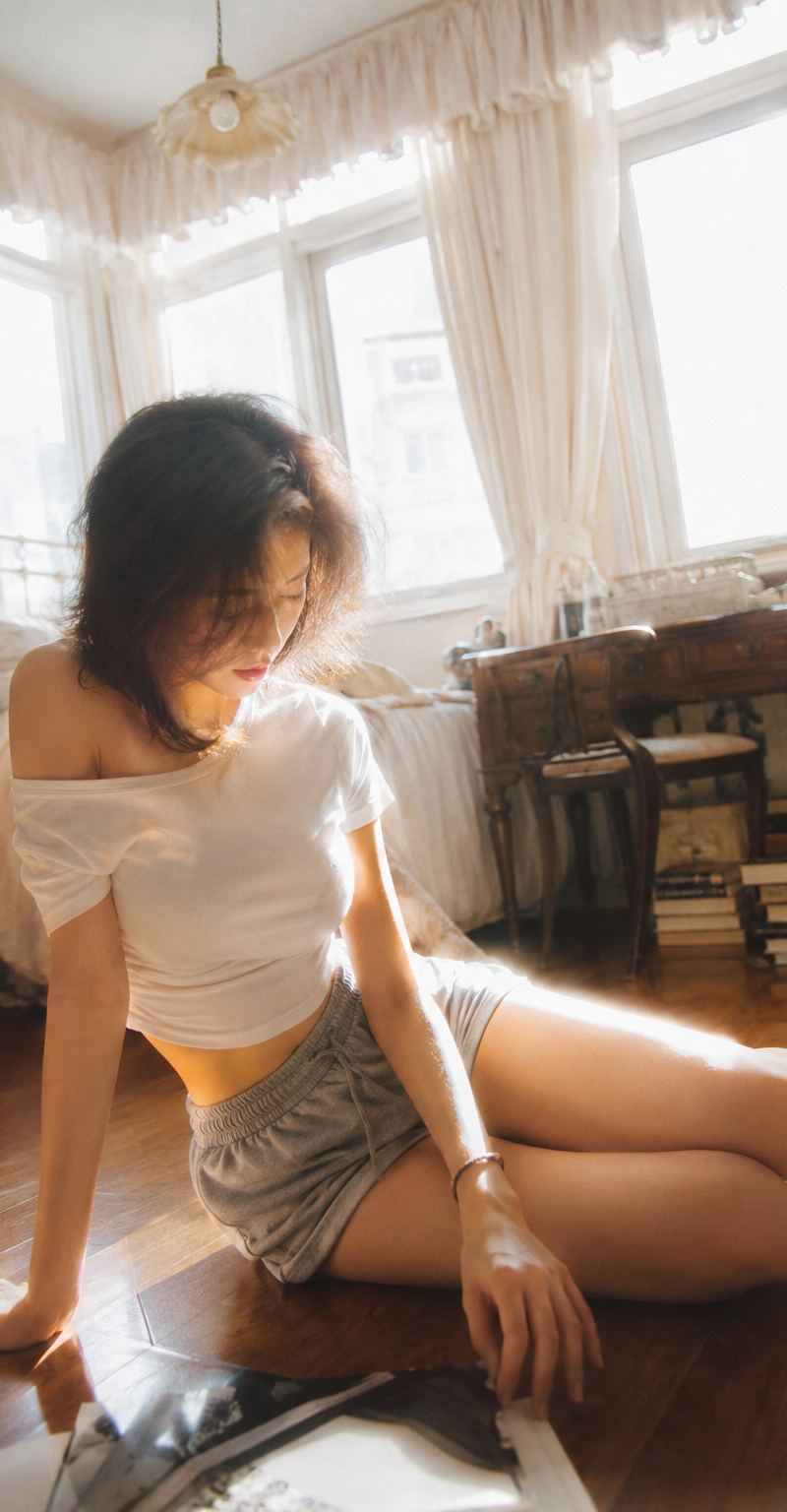 { "subject": { "description": "A young adult woman sitting on a bedroom floor, c