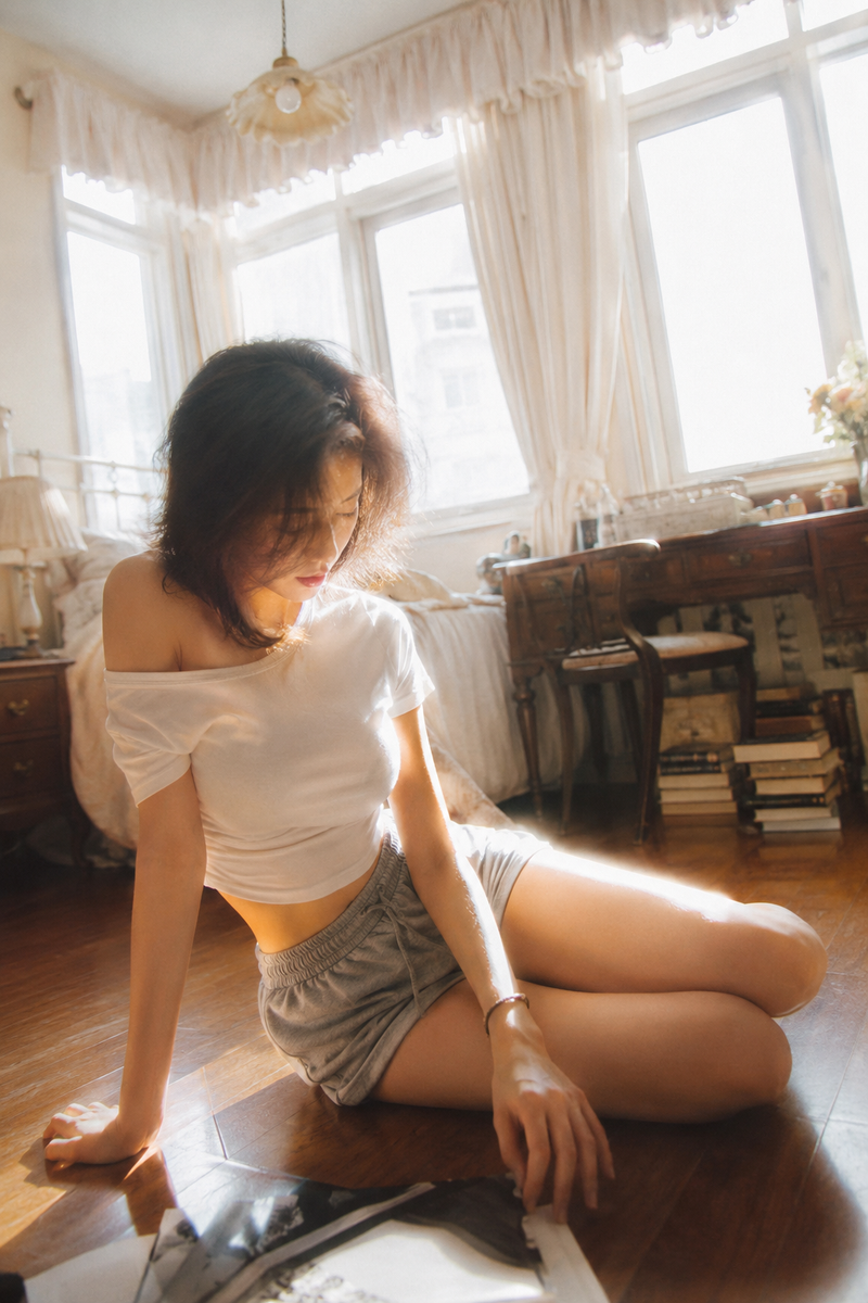 { "subject": { "description": "A young adult woman sitting on a bedroom floor, c