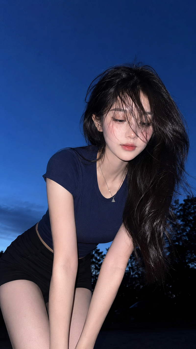 { "subject": { "description": "A young adult woman leaning forward outdoors at d