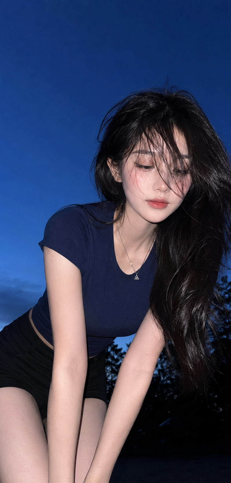 { "subject": { "description": "A young adult woman leaning forward outdoors at d