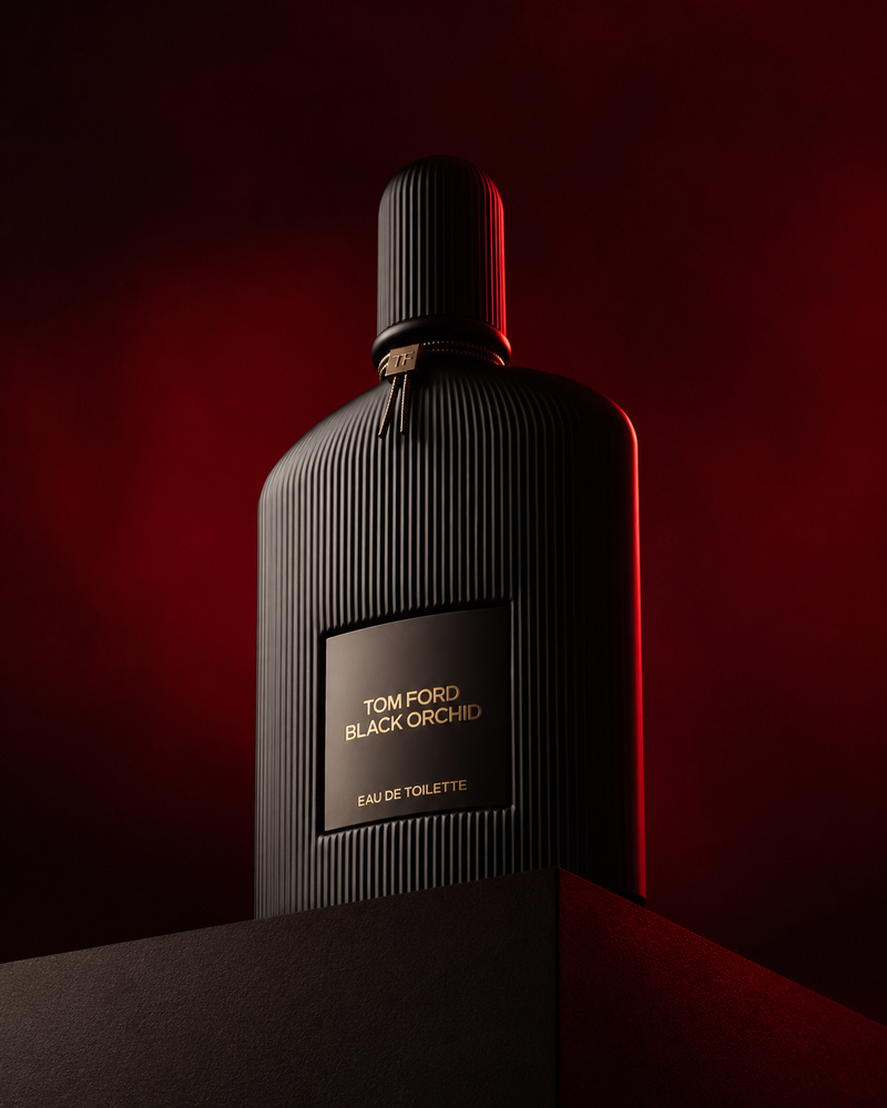 Low angle luxury product photography of a black ribbed glass perfume bottle plac