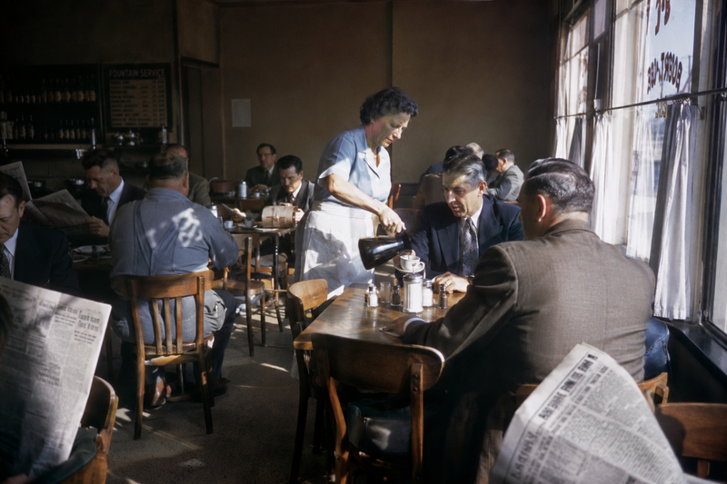 1954 neighborhood coffee shop filled with office workers reading newspapers, wai