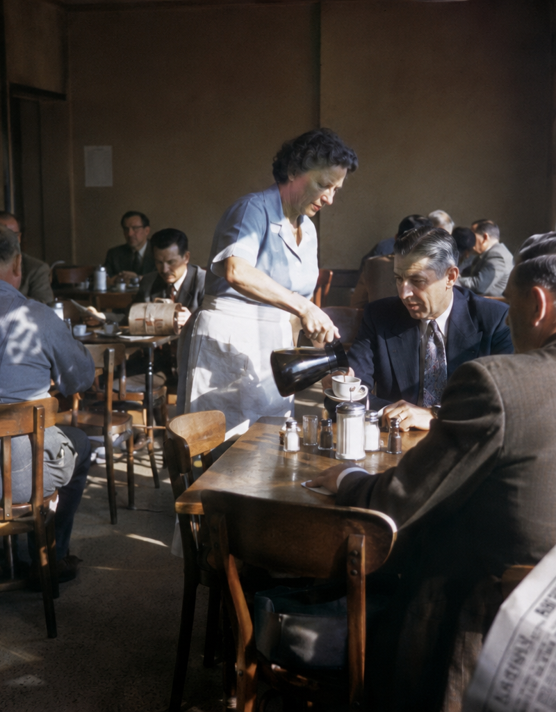 1954 neighborhood coffee shop filled with office workers reading newspapers, wai