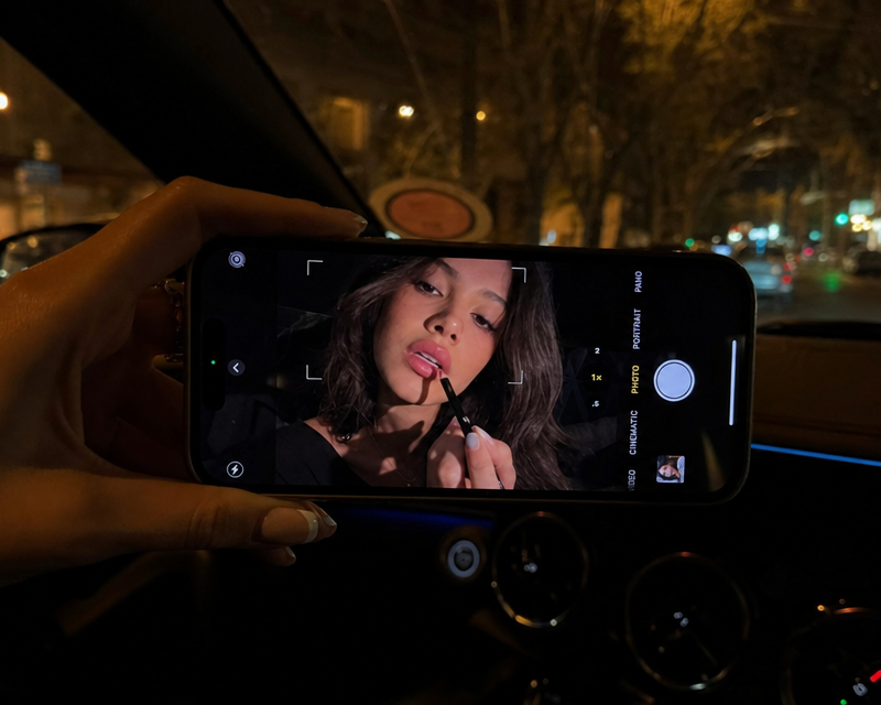 The photo is taken inside a car at night