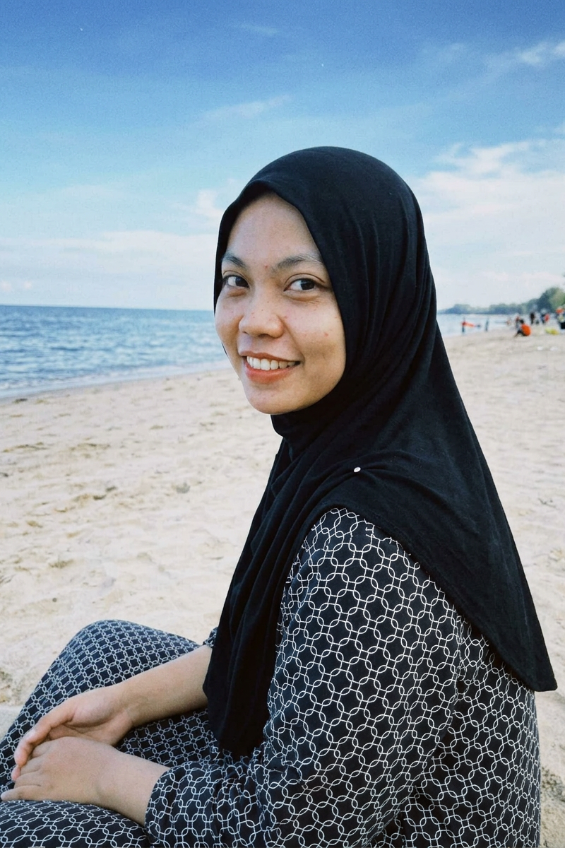 { "subject": { "description": "A young adult woman sitting on a sandy beach with